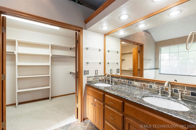 3701 Bridgeport Rd, Norman, OK 73072 - bathroom featuring double vanity, a spacious closet, recessed lighting, and lofted ceiling