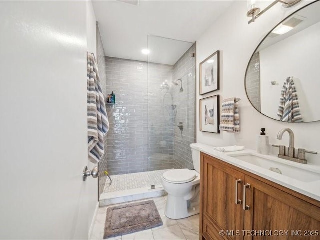 full bathroom featuring a stall shower, vanity, and toilet