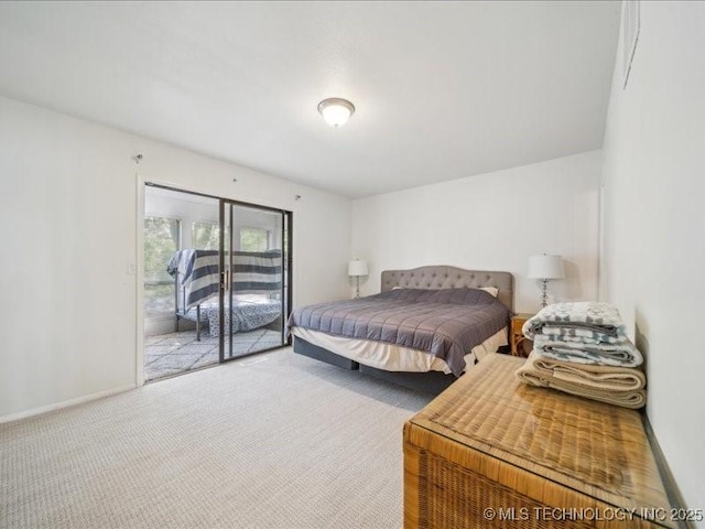 carpeted bedroom with baseboards and access to exterior