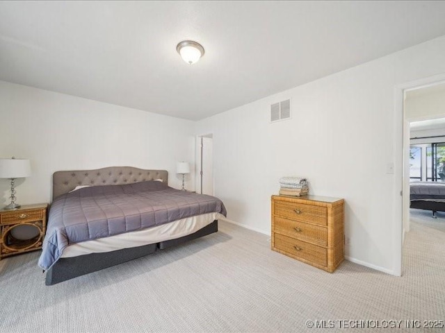 bedroom featuring visible vents, carpet flooring, and baseboards