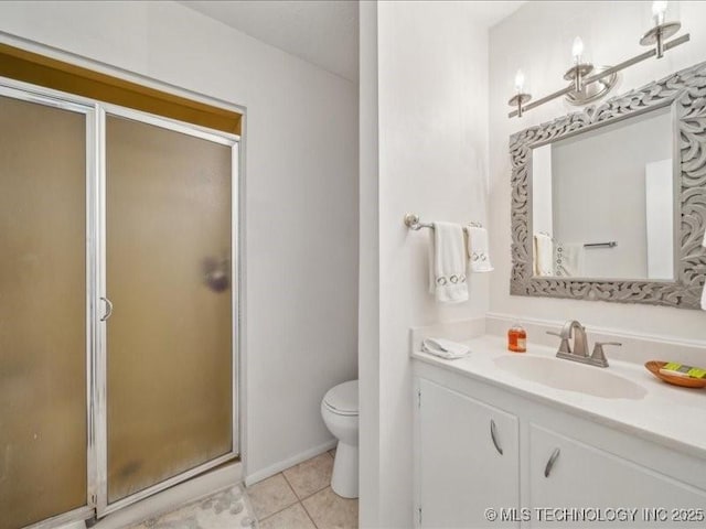 bathroom with toilet, vanity, tile patterned floors, and a stall shower