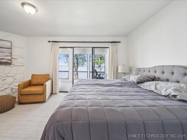 bedroom featuring vaulted ceiling, carpet floors, and access to exterior