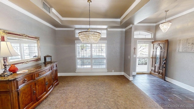 foyer featuring baseboards, a notable chandelier, a healthy amount of sunlight, and visible vents