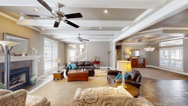living area featuring beamed ceiling, baseboards, ceiling fan, recessed lighting, and a fireplace with raised hearth