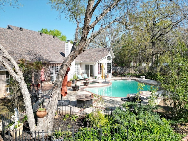 view of swimming pool with a fenced in pool, fence, a patio, and a hot tub