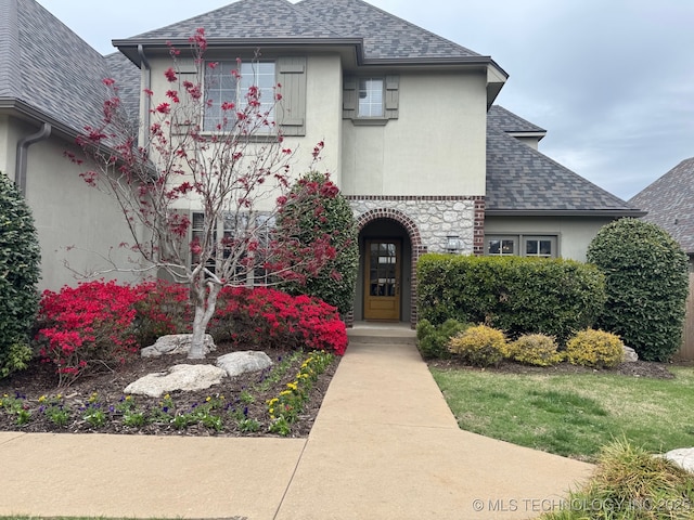 12330 S Ash Ave, Jenks, OK 74037 - view of front of house with a shingled roof and stucco siding