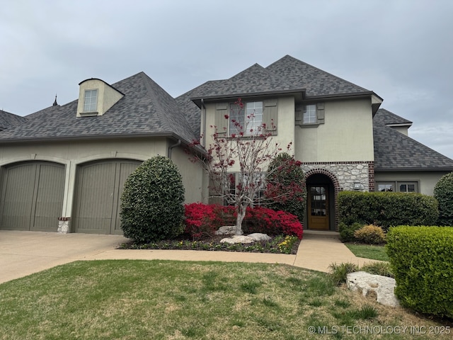 12330 S Ash Ave, Jenks, OK 74037 - french country style house with roof with shingles, a garage, driveway, stucco siding, and a front yard