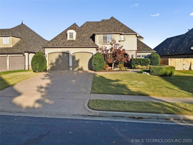 12330 S Ash Ave, Jenks, OK 74037 - view of front facade featuring an attached garage, a front lawn, concrete driveway, stucco siding, and stone siding