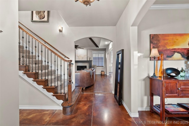 12330 S Ash Ave, Jenks, OK 74037 - entryway with a ceiling fan, arched walkways, baseboards, a fireplace, and stairway