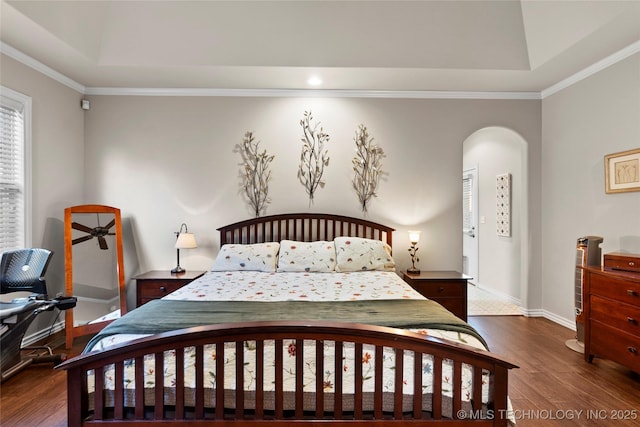 12330 S Ash Ave, Jenks, OK 74037 - bedroom featuring wood finished floors, a tray ceiling, baseboards, arched walkways, and ornamental molding