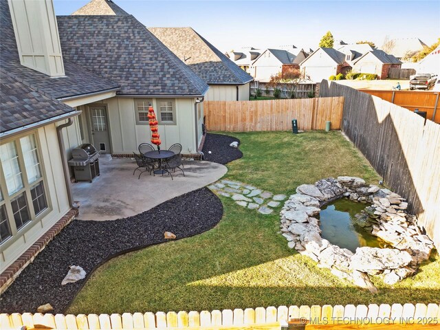 12330 S Ash Ave, Jenks, OK 74037 - view of yard featuring a patio area, a residential view, and a small pond