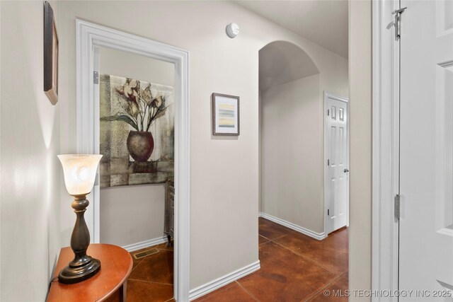 12330 S Ash Ave, Jenks, OK 74037 - corridor featuring concrete flooring, arched walkways, and baseboards
