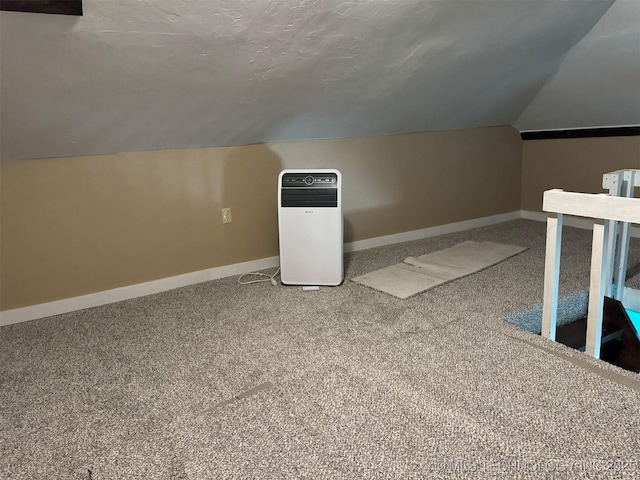 bonus room featuring carpet flooring, vaulted ceiling, and baseboards