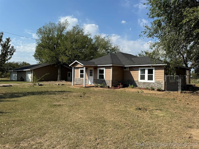ranch-style home with a front yard, stone siding, and fence