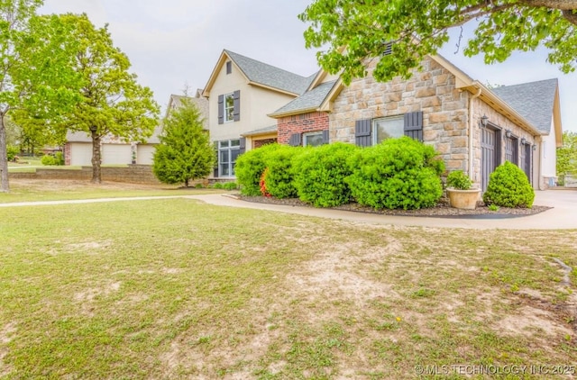 461 Cross Timbers Blvd, Sapulpa, OK 74066 - view of front facade with a shingled roof, a front lawn, and stone siding