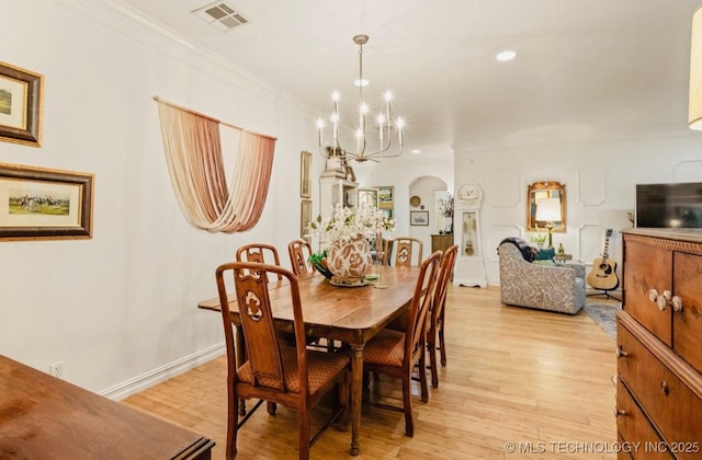 461 Cross Timbers Blvd, Sapulpa, OK 74066 - dining room with a notable chandelier, crown molding, visible vents, light wood-style flooring, and arched walkways