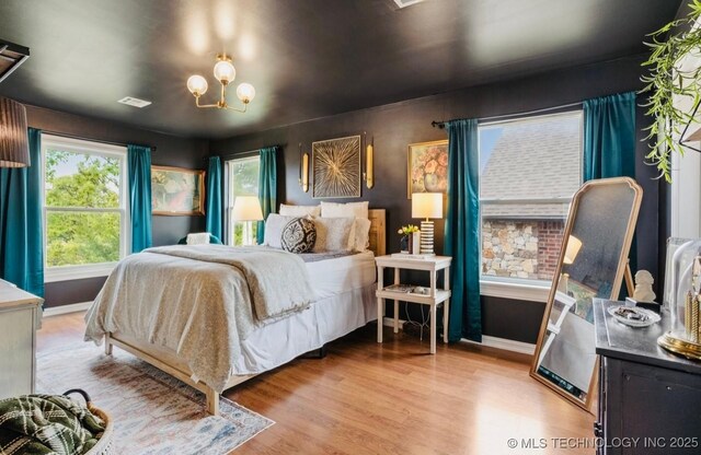 461 Cross Timbers Blvd, Sapulpa, OK 74066 - bedroom with a chandelier, baseboards, wood finished floors, and visible vents