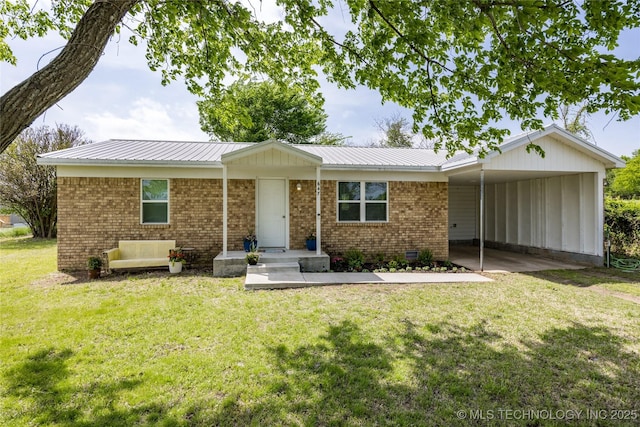 647 Sawmill Rd, Durant, OK 74701 - view of front of property with brick siding, a carport, a front yard, and metal roof