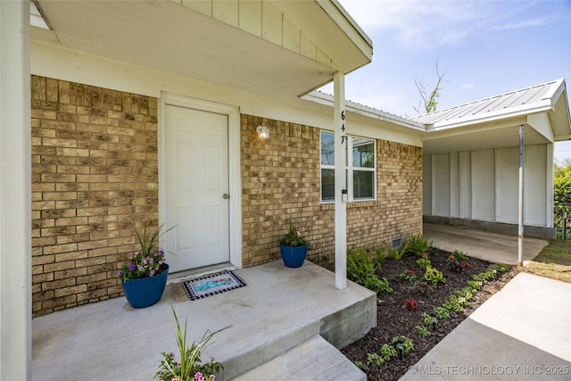 647 Sawmill Rd, Durant, OK 74701 - view of exterior entry featuring brick siding, crawl space, and metal roof