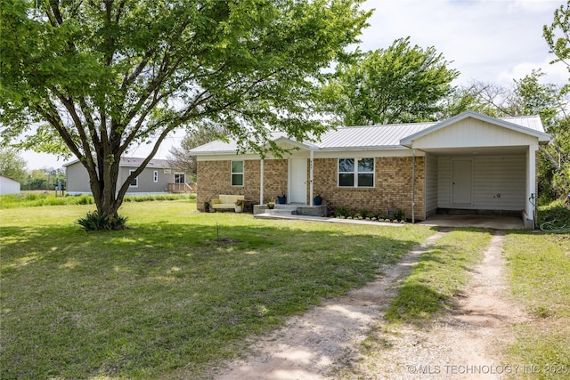 647 Sawmill Rd, Durant, OK 74701 - ranch-style home with a front lawn, driveway, an attached carport, metal roof, and brick siding