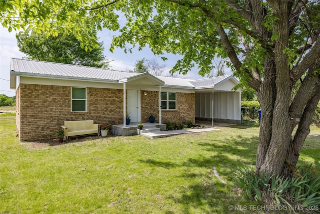 647 Sawmill Rd, Durant, OK 74701 - view of front facade with a front lawn, brick siding, an attached carport, and metal roof