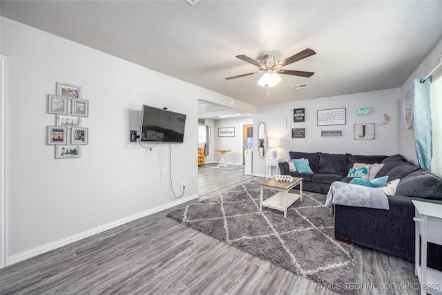 647 Sawmill Rd, Durant, OK 74701 - living area with visible vents, baseboards, wood finished floors, and ceiling fan