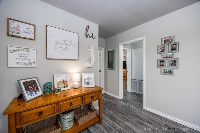 647 Sawmill Rd, Durant, OK 74701 - hallway featuring visible vents, baseboards, and dark wood-style floors