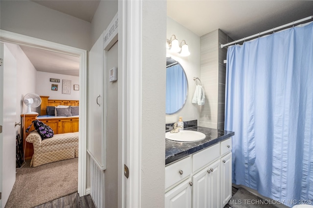 647 Sawmill Rd, Durant, OK 74701 - ensuite bathroom with wood finished floors, vanity, and connected bathroom