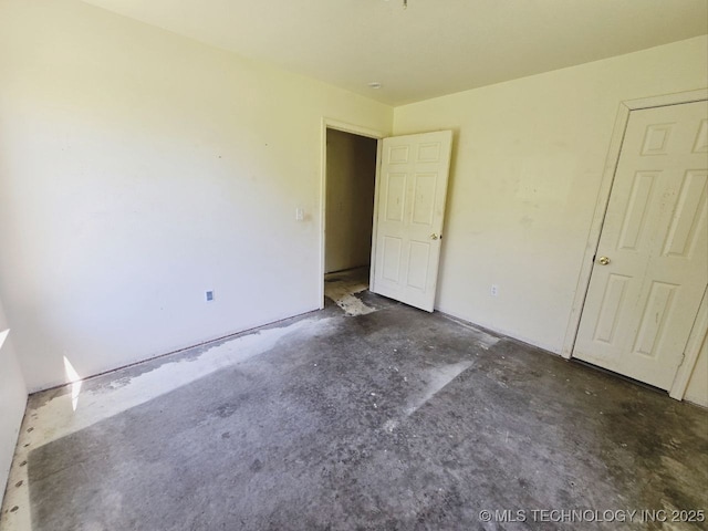 unfurnished bedroom featuring concrete flooring
