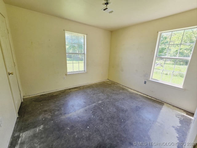 unfurnished room featuring concrete floors and visible vents