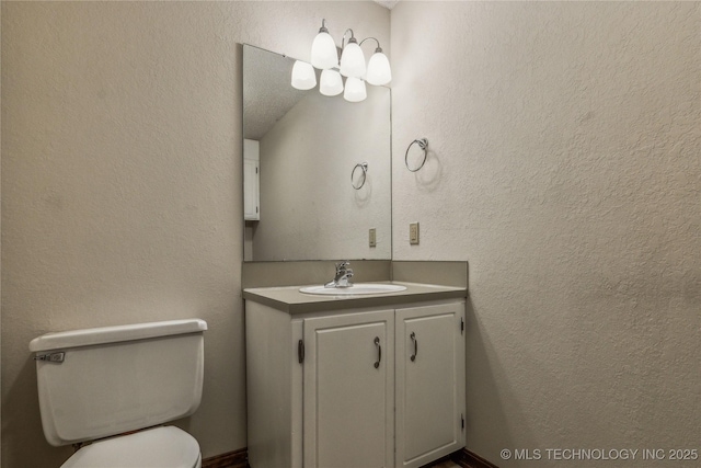 half bathroom with toilet and vanity
