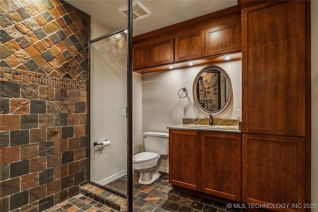 bathroom with visible vents, toilet, stone finish flooring, baseboards, and walk in shower