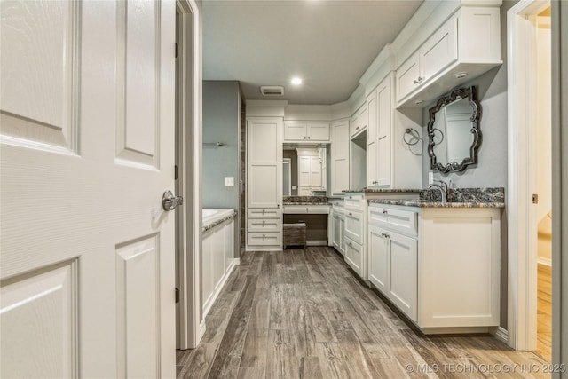 full bath featuring vanity, wood finished floors, visible vents, and recessed lighting