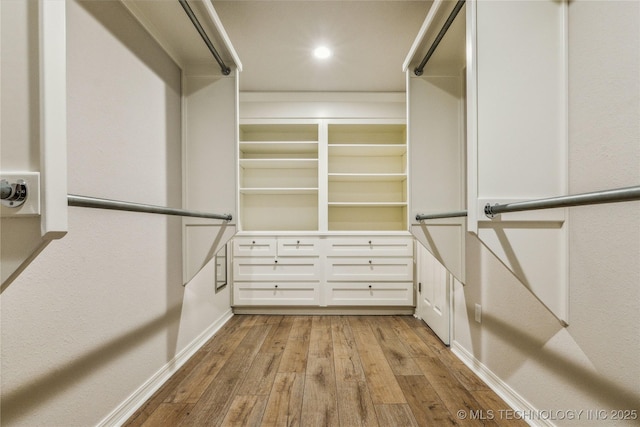 walk in closet featuring light wood finished floors
