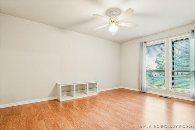 21083 Stick Ross Mountain Rd, Tahlequah, OK 74464 - spare room featuring wood finished floors, baseboards, and a ceiling fan