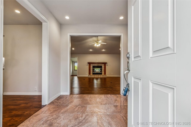21083 Stick Ross Mountain Rd, Tahlequah, OK 74464 - foyer entrance with wood finished floors, ceiling fan, recessed lighting, a tile fireplace, and baseboards