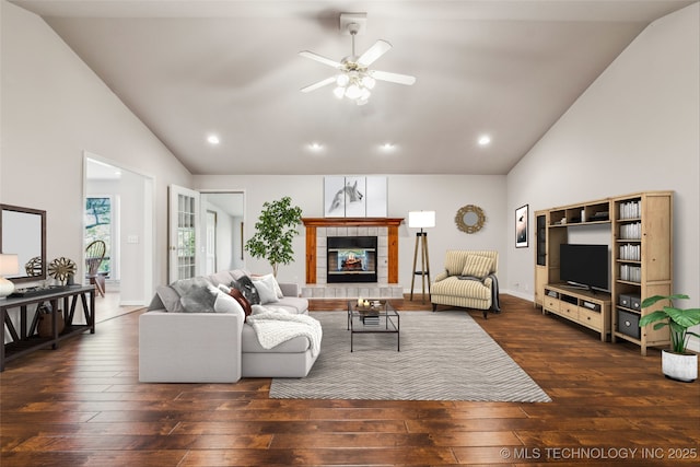 living room featuring recessed lighting, lofted ceiling, a ceiling fan, hardwood / wood-style flooring, and a fireplace