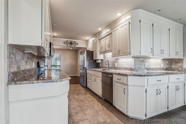 kitchen featuring light stone counters, tasteful backsplash, stainless steel appliances, and white cabinetry