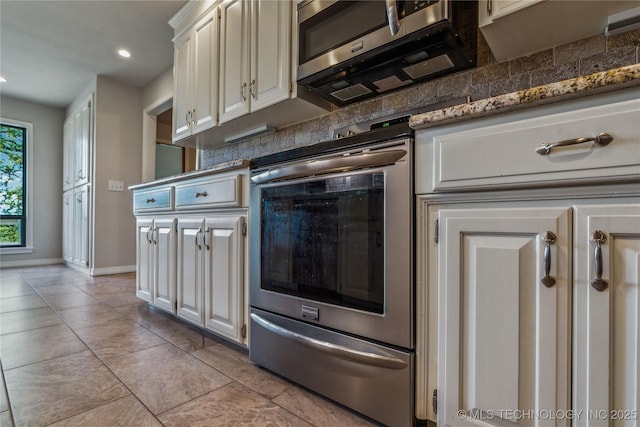 21083 Stick Ross Mountain Rd, Tahlequah, OK 74464 - kitchen with appliances with stainless steel finishes, baseboards, recessed lighting, backsplash, and white cabinetry