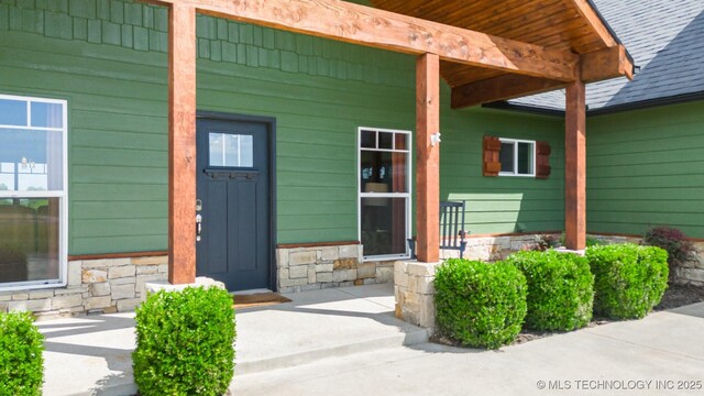 9153 S 4270th Rd, Chelsea, OK 74016 - doorway to property featuring a porch and stone siding
