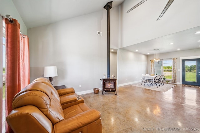 9153 S 4270th Rd, Chelsea, OK 74016 - living room with recessed lighting, visible vents, a wood stove, baseboards, and finished concrete floors