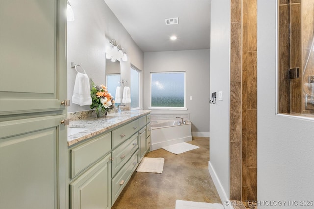 9153 S 4270th Rd, Chelsea, OK 74016 - bathroom featuring double vanity, a sink, visible vents, concrete flooring, and a garden tub