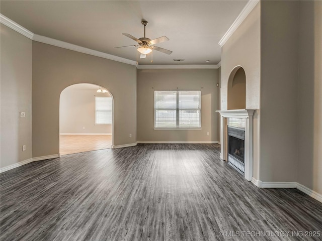 12520 S Birch Ave, Jenks, OK 74037 - unfurnished living room featuring a ceiling fan, dark wood-style floors, a glass covered fireplace, crown molding, and arched walkways