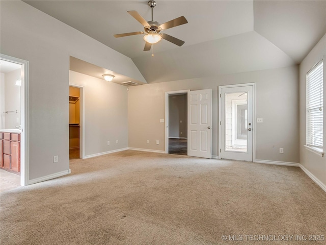 12520 S Birch Ave, Jenks, OK 74037 - unfurnished bedroom featuring vaulted ceiling, light colored carpet, a walk in closet, ensuite bath, and a ceiling fan