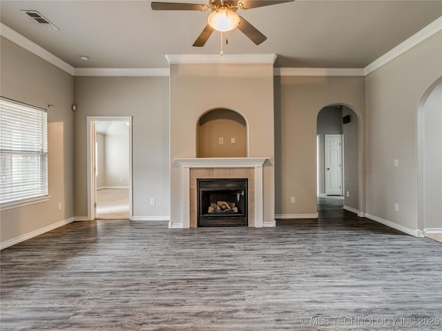 12520 S Birch Ave, Jenks, OK 74037 - unfurnished living room featuring wood finished floors, ceiling fan, crown molding, arched walkways, and a fireplace