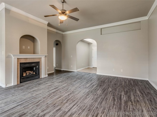 12520 S Birch Ave, Jenks, OK 74037 - unfurnished living room with wood finished floors, ornamental molding, ceiling fan, a tile fireplace, and arched walkways