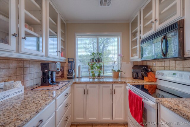 3249 S 138th E Ave, Tulsa, OK 74134 - kitchen featuring white range with electric stovetop, white cabinets, black microwave, backsplash, and visible vents