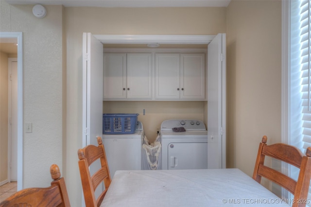 3249 S 138th E Ave, Tulsa, OK 74134 - clothes washing area with cabinet space, a healthy amount of sunlight, light tile patterned flooring, and separate washer and dryer