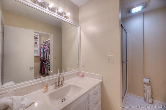 3249 S 138th E Ave, Tulsa, OK 74134 - bathroom with a shower stall, visible vents, and vanity