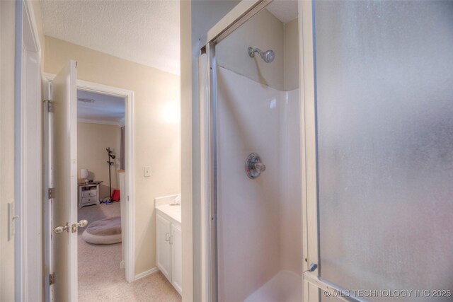 3249 S 138th E Ave, Tulsa, OK 74134 - bathroom with a shower stall, crown molding, and vanity